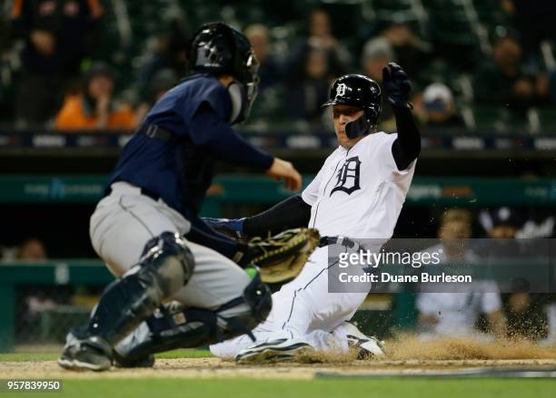 JaCoby Jones of the Detroit Tigers scores from first base against catcher David Freitas of the Seattle Mariners on a double by Pete Kozma of the...