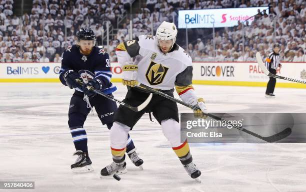 Brayden McNabb of the Vegas Golden Knights is defended by Kyle Connor of the Winnipeg Jets in Game One of the Western Conference Finals during the...