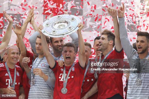 Thomas Mueller of Bayern Muenchen lifts the trophy in Celebration for winning the German Champiosnhip title after the Bundesliga match between FC...