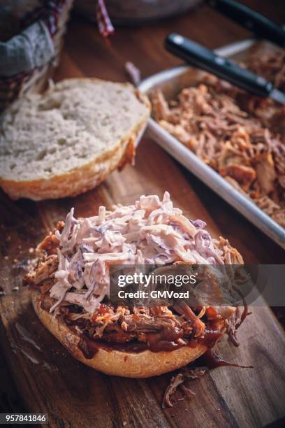 messy pulled pork burger with coleslaw - pickled pork stock pictures, royalty-free photos & images