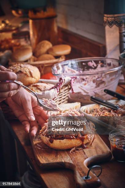 messy pulled pork burger with coleslaw - pickled pork stock pictures, royalty-free photos & images