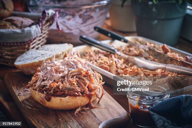 messy pulled pork burger with coleslaw - barbecue sandwich stock pictures, royalty-free photos & images