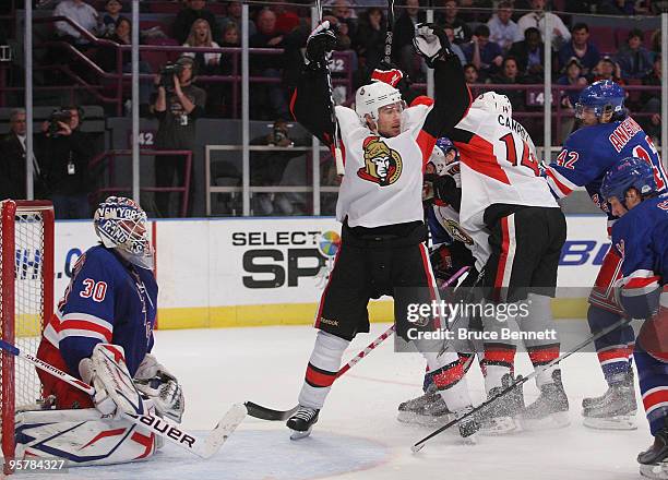 Henrik Lundqvist of the New York Rangers is beaten by a shot from Chris Campoli of the Ottawa Senators as Mike Fisher celebrates at Madison Square...