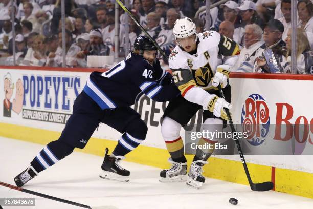 Joel Armia of the Winnipeg Jets and David Perron of the Vegas Golden Knights battle for the puck during the third period in Game One of the Western...