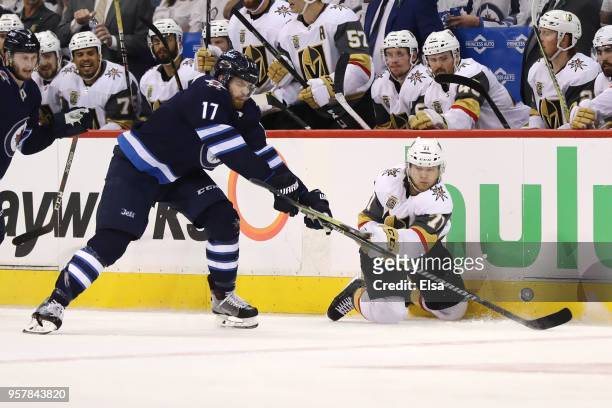 William Karlsson of the Vegas Golden Knights is defended by Adam Lowry of the Winnipeg Jets during the third period in Game One of the Western...