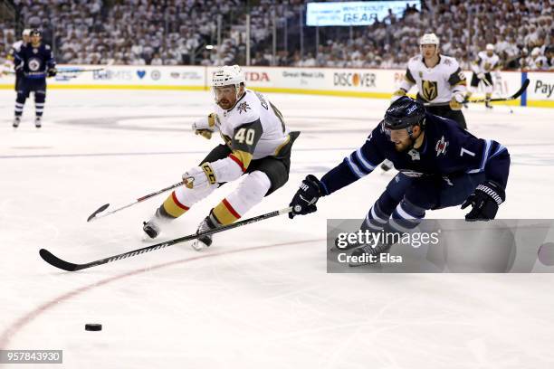 Ryan Carpenter of the Vegas Golden Knights is defended by Ben Chiarot of the Winnipeg Jets during the third period in Game One of the Western...