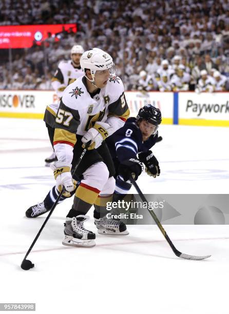 David Perron of the Vegas Golden Knights is defended by Andrew Copp of the Winnipeg Jets during the third period in Game One of the Western...