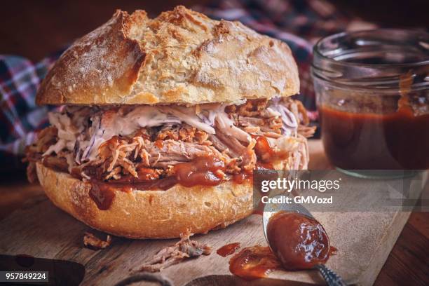 messy pulled pork burger with coleslaw - pickled pork stock pictures, royalty-free photos & images