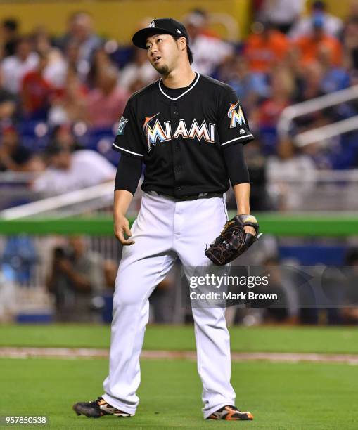 Junichi Tazawa of the Miami Marlins reacts to a call of one of his pitches in the eighth inning against the Atlanta Braves at Marlins Park on May 12,...