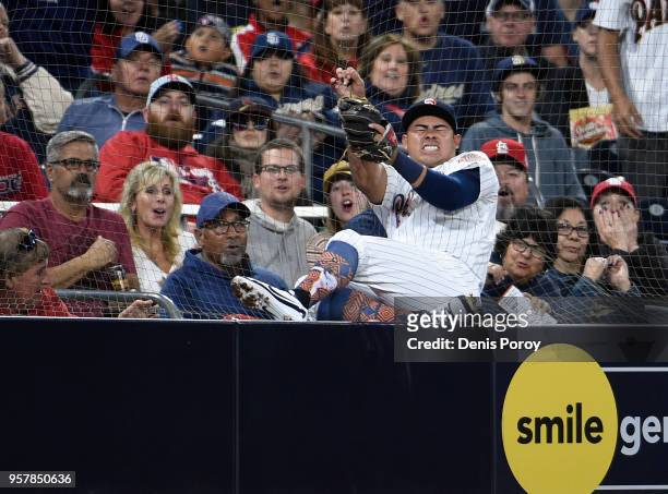 Christian Villanueva of the San Diego Padres crashes into the net as he chases a foul ball hit by Dexter Fowler of the St. Louis Cardinals during the...