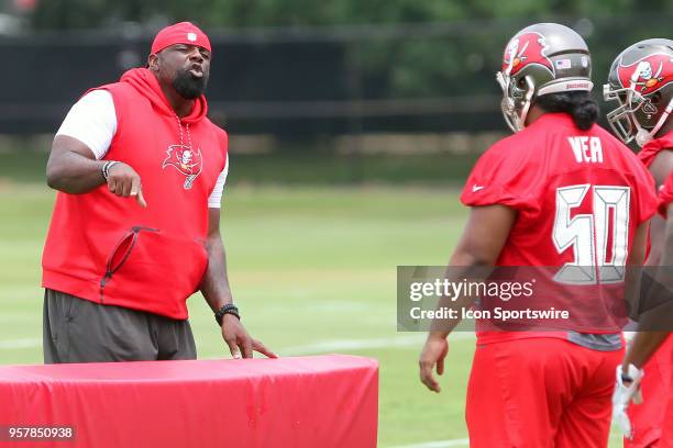 Defensive line coach Brentson Buckner gives instructions to 2018 first round pick Vita Vea during the Tampa Bay Buccaneers Rookie Minicamp on May 12,...