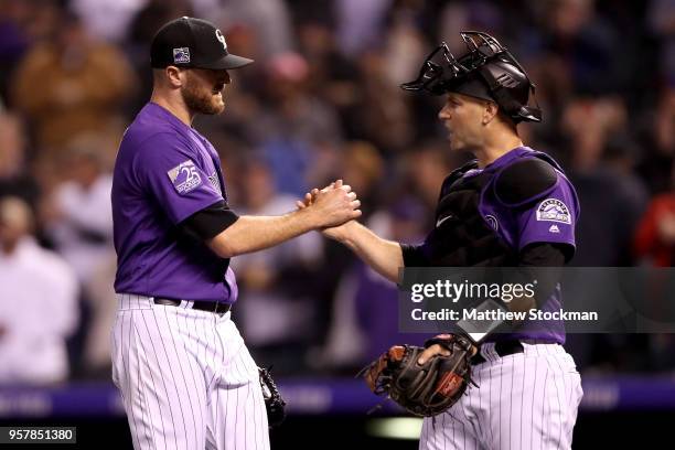 Pitcher Wade Davis and catcher Chris Iannetta of the Colorado Rockies celebrate their win against the Milwaukee Brewers at Coors Field on May 12,...