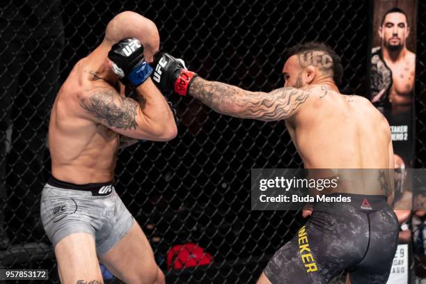 John Lineker of the Brazil punches Brian Kelleher of the United States in their bantamweight bout during the UFC 224 event at Jeunesse Arena on May...