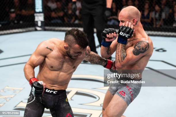 John Lineker of the Brazil punches Brian Kelleher of the United States in their bantamweight bout during the UFC 224 event at Jeunesse Arena on May...