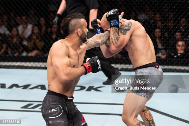 John Lineker of the Brazil punches Brian Kelleher of the United States in their bantamweight bout during the UFC 224 event at Jeunesse Arena on May...