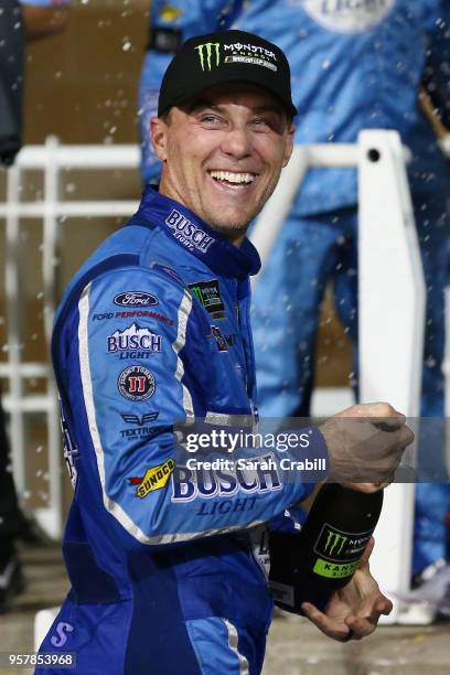 Kevin Harvick, driver of the Busch Light Ford, celebrates in victory lane after winning the Monster Energy NASCAR Cup Series KC Masterpiece 400 at...