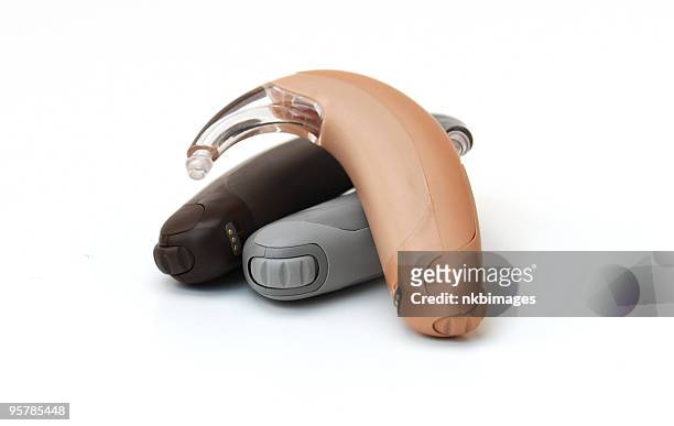 three digital bte (behind the ear) hearing aids - hearing aids stock pictures, royalty-free photos & images