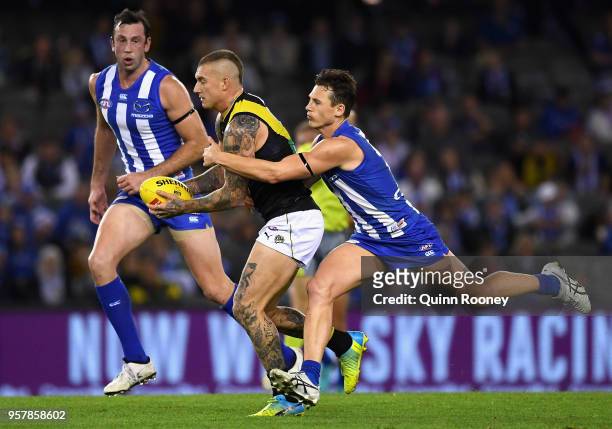 Dustin Martin of the Tigers is tackled by Ben Jacobs of the Kangaroos during the round eight AFL match between the North Melbourne Kangaroos and the...