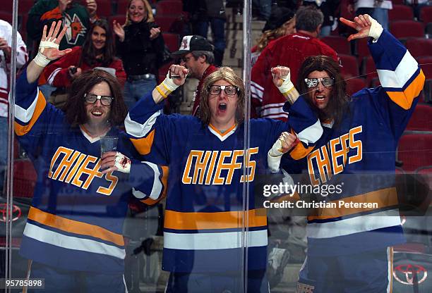 Fans dressed as the Hanson Brothers cheer along the boards following the NHL game between the New Jersey Devils and the Phoenix Coyotes at Jobing.com...