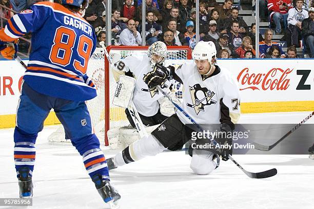 Jay McKee and Marc-Andre Fleury of the Pittsburgh Penguins go down to stop a shot from Sam Gagner of the Edmonton Oilers at Rexall Place on January...