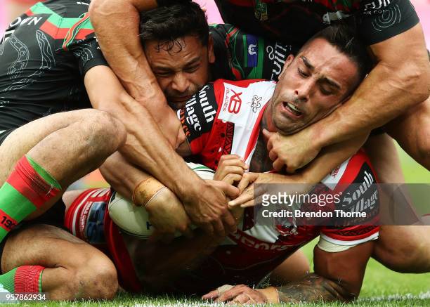 Paul Vaughan of the Dragons is tackled by the Rabbitohs defence during the round 10 NRL match between the South Sydney Rabbitohs and the St George...