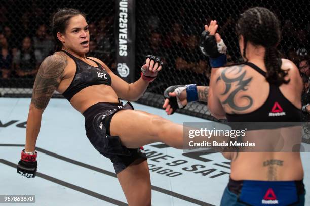 Amanda Nunes of Brazil kicks Raquel Pennington of the United States in their women's bantamweight bout during the UFC 224 event at Jeunesse Arena on...