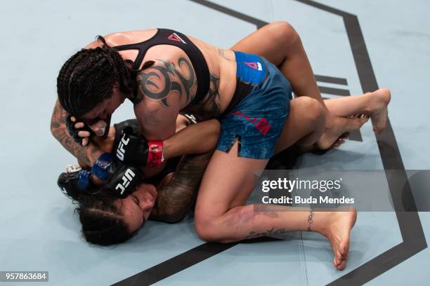 Raquel Pennington of the United States controls the body of Amanda Nunes of Brazil in their women's bantamweight bout during the UFC 224 event at...