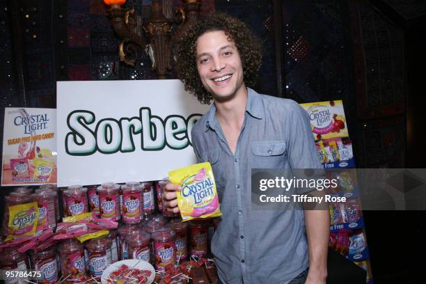 Recording artist Justin Guarini poses with Sorbee sugar free candy at the Hollywood Helping Haiti Golden Globes Celebrity & Charity Lounge - Day 1 at...