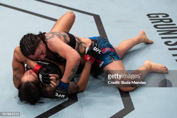 Raquel Pennington of the United States controls the body of Amanda Nunes of Brazil in their women's bantamweight bout during the UFC 224 event at...
