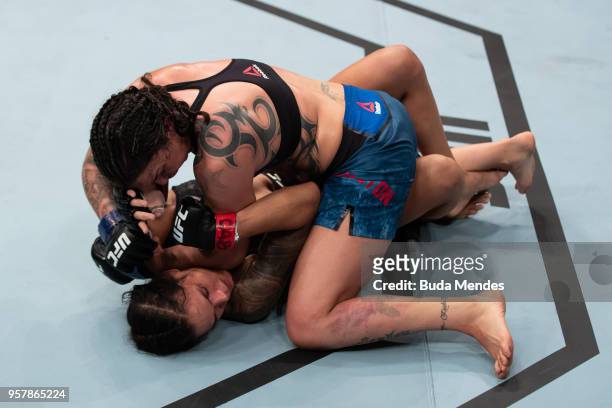 Raquel Pennington of the United States controls the body of Amanda Nunes of Brazil in their women's bantamweight bout during the UFC 224 event at...