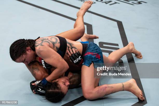 Raquel Pennington of the United States controls the body of Amanda Nunes of Brazil in their women's bantamweight bout during the UFC 224 event at...