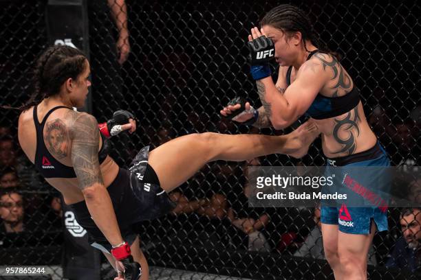 Amanda Nunes of Brazil kicks Raquel Pennington of the United States in their women's bantamweight bout during the UFC 224 event at Jeunesse Arena on...