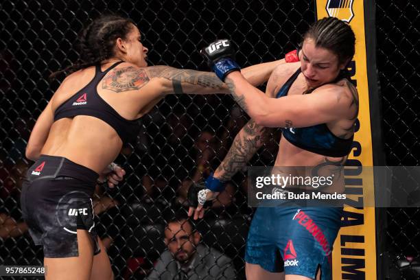 Amanda Nunes of Brazil punches Raquel Pennington of the United States in their women's bantamweight bout during the UFC 224 event at Jeunesse Arena...