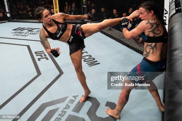 Amanda Nunes of Brazil kicks Raquel Pennington of the United States in their women's bantamweight bout during the UFC 224 event at Jeunesse Arena on...