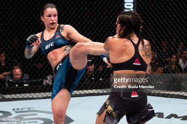 Raquel Pennington of the United States kicks Amanda Nunes of Brazil in their women's bantamweight bout during the UFC 224 event at Jeunesse Arena on...