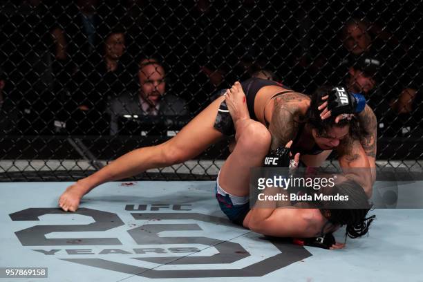 Amanda Nunes of Brazil submits Raquel Pennington of the United States in their women's bantamweight bout during the UFC 224 event at Jeunesse Arena...