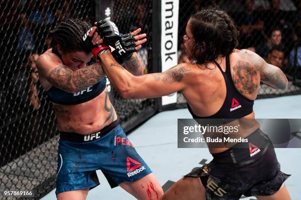 Amanda Nunes of Brazil punches Raquel Pennington of the United States in their women's bantamweight bout during the UFC 224 event at Jeunesse Arena...