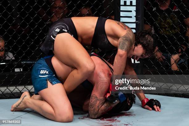 Amanda Nunes of Brazil submit Raquel Pennington of the United States in their women's bantamweight bout during the UFC 224 event at Jeunesse Arena on...