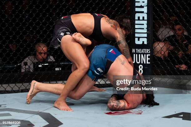 Amanda Nunes of Brazil submit Raquel Pennington of the United States in their women's bantamweight bout during the UFC 224 event at Jeunesse Arena on...