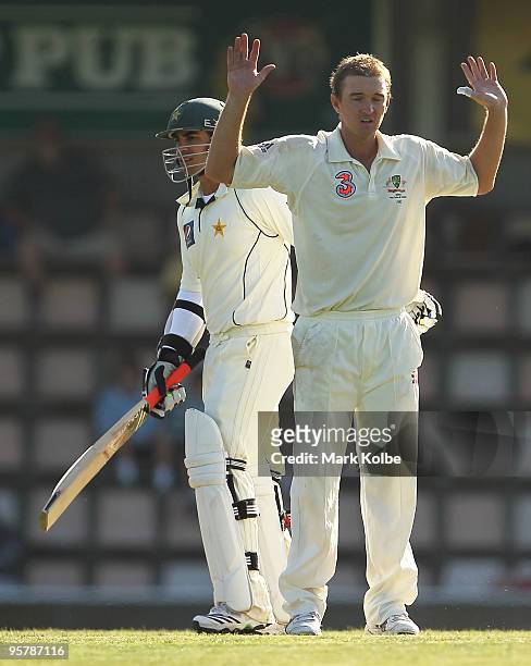Nathan Hauritz of Australia puts his hands up after colliding with Salman Butt of Pakistan during day two of the Third Test match between Australia...