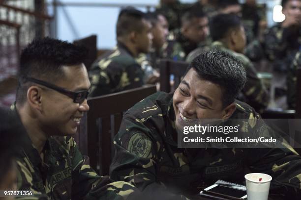 Philippine Air Force airmen share a laugh during a fiber optics termination class, Clark Air Base, Philippines, May 9, 2018. Image courtesy Senior...
