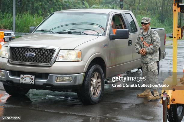 Task Force Hawaii Security Team SPC Robert Harrington control vehicle at a traffic control point during a volcanic outbreak, Pahoa Hawaii, May 8,...