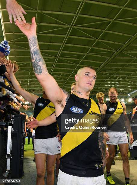 Dustin Martin of the Tigers high fives fans after winning the round eight AFL match between the North Melbourne Kangaroos and the Richmond Tigers at...