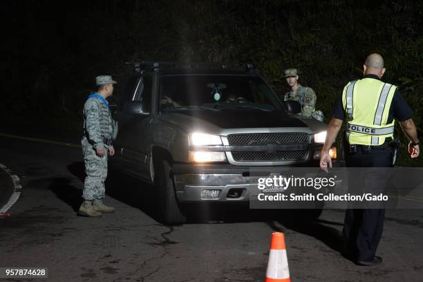 Hawaii National Guard soldiers assisting a Hawaii Police Officer in traffic control during a volcanic outbreak, Pahoa Hawaii, May 6, 2018. Image...