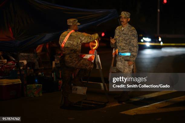 Hawaii Air National Guard's 291st Combat Communication Tech Sgt Mason Nakayama speaking with a Hawaii Army National Guard Soldier during a volcanic...