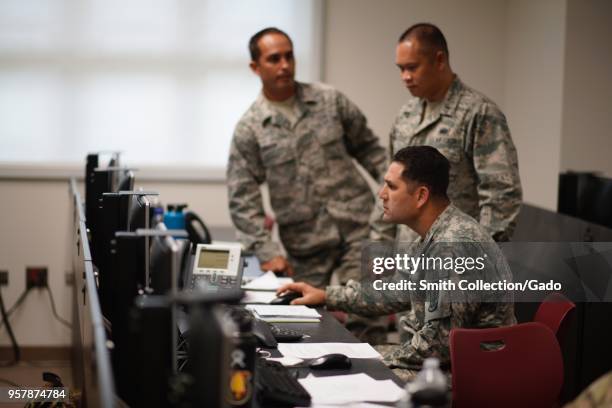 Three members of the Hawaii National Guard's Task Force working at the office during a volcanic outbreak, Hilo Hawaii, May 6, 2018. Image courtesy...