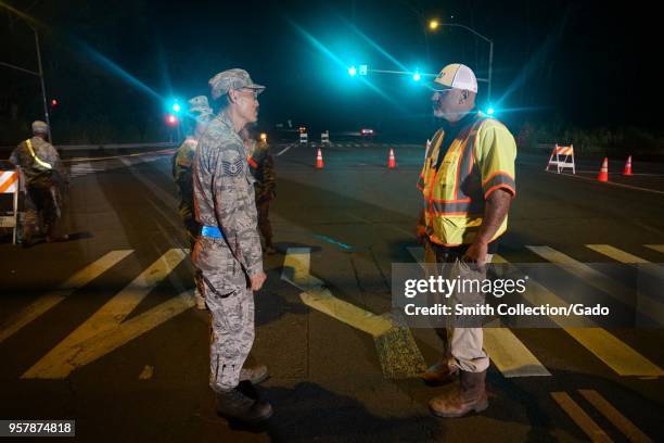 Hawaii Air National Guard's 291st Combat Communication Tech Sgt Mason Nakayama speaking with local traffic worker while assisting the Hawaii Police...