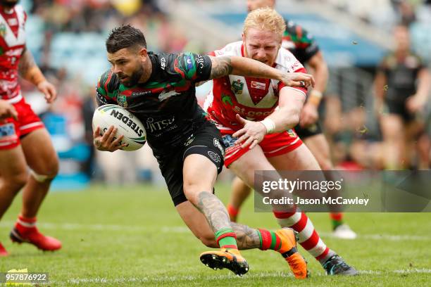 Adam Reynolds of the Rabbitohs is tackled by James Graham of the Dragons during the round 10 NRL match between the South Sydney Rabbitohs and the St...