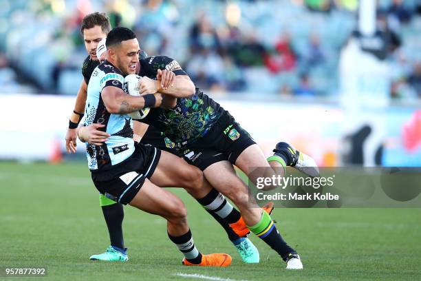 Valentine Holmes of the Sharks is tackled during the round 10 NRL match between the Canberra Raiders and the Cronulla Sharks at GIO Stadium on May...