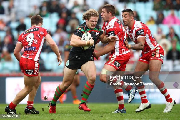 George Burgess of the Rabbitohs is tackled by the Dragons defence during the round 10 NRL match between the South Sydney Rabbitohs and the St George...